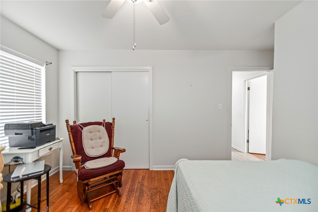 207 Williams Street Tivoli, TX 77990 - Photo 23 of 32 a bedroom with a bed and a chandelier