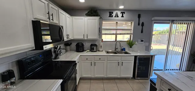 a kitchen with stainless steel appliances a sink stove and cabinets