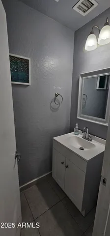 a bathroom with a sink a mirror and a toilet