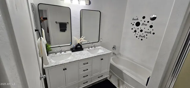 a bathroom with a double vanity sink and mirror