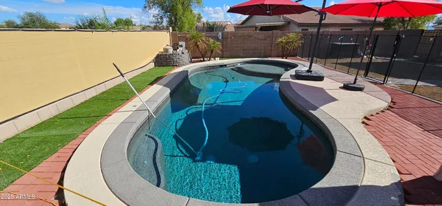 a view of a swimming pool with a patio
