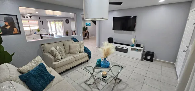 a living room with furniture and a flat screen tv