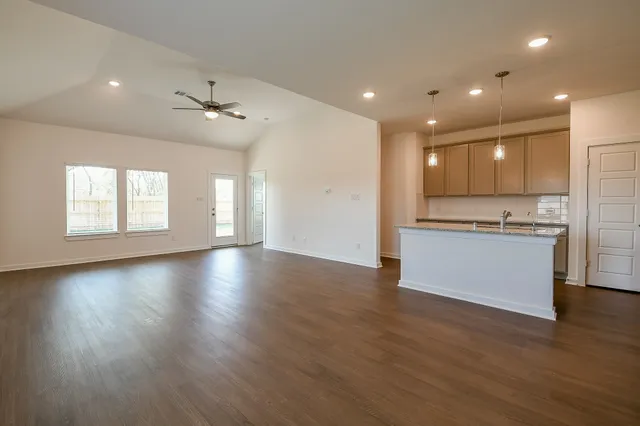 a view of kitchen with sink and refrigerator