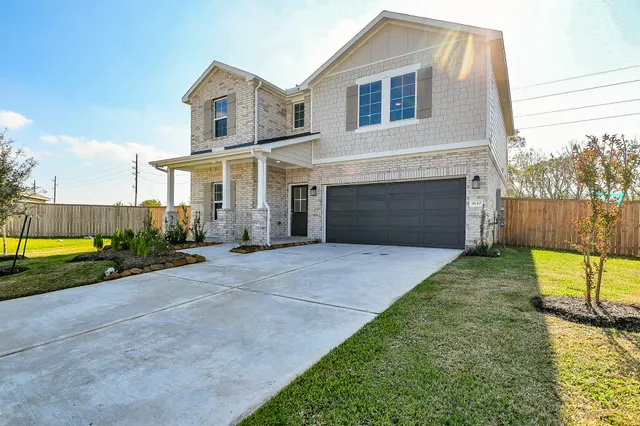 a front view of a house with yard and a garage