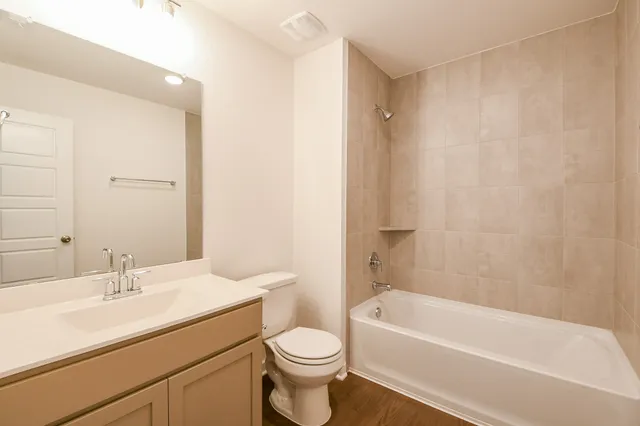 a bathroom with a sink a toilet and a bathtub