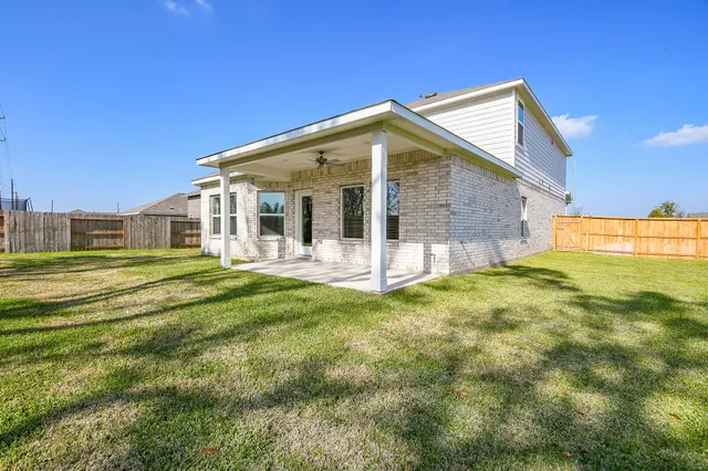 a view of a house with a yard and sitting area