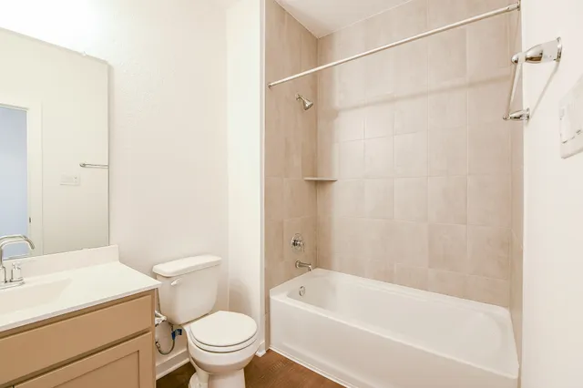 a white toilet sitting next to a bath tub