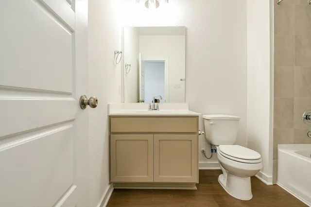 a bathroom with a sink a toilet and a mirror