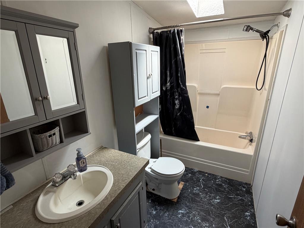 4541 Main Street Slatington, PA 18080 - Photo 11 of 27 A well-appointed bathroom featuring a clean vanity, mirrored medicine cabinet, and a functional tub/shower combination.