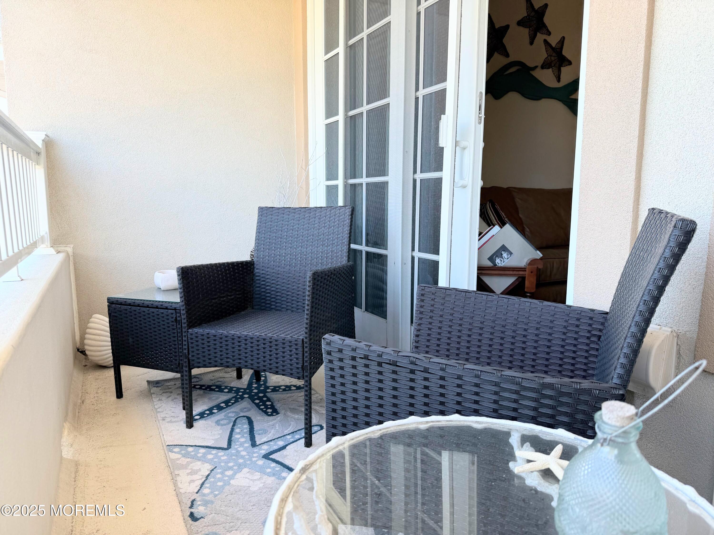2 Main Street, Unit 308 Bradley Beach, NJ 07720 - Photo 13 of 31 a balcony with table and chairs