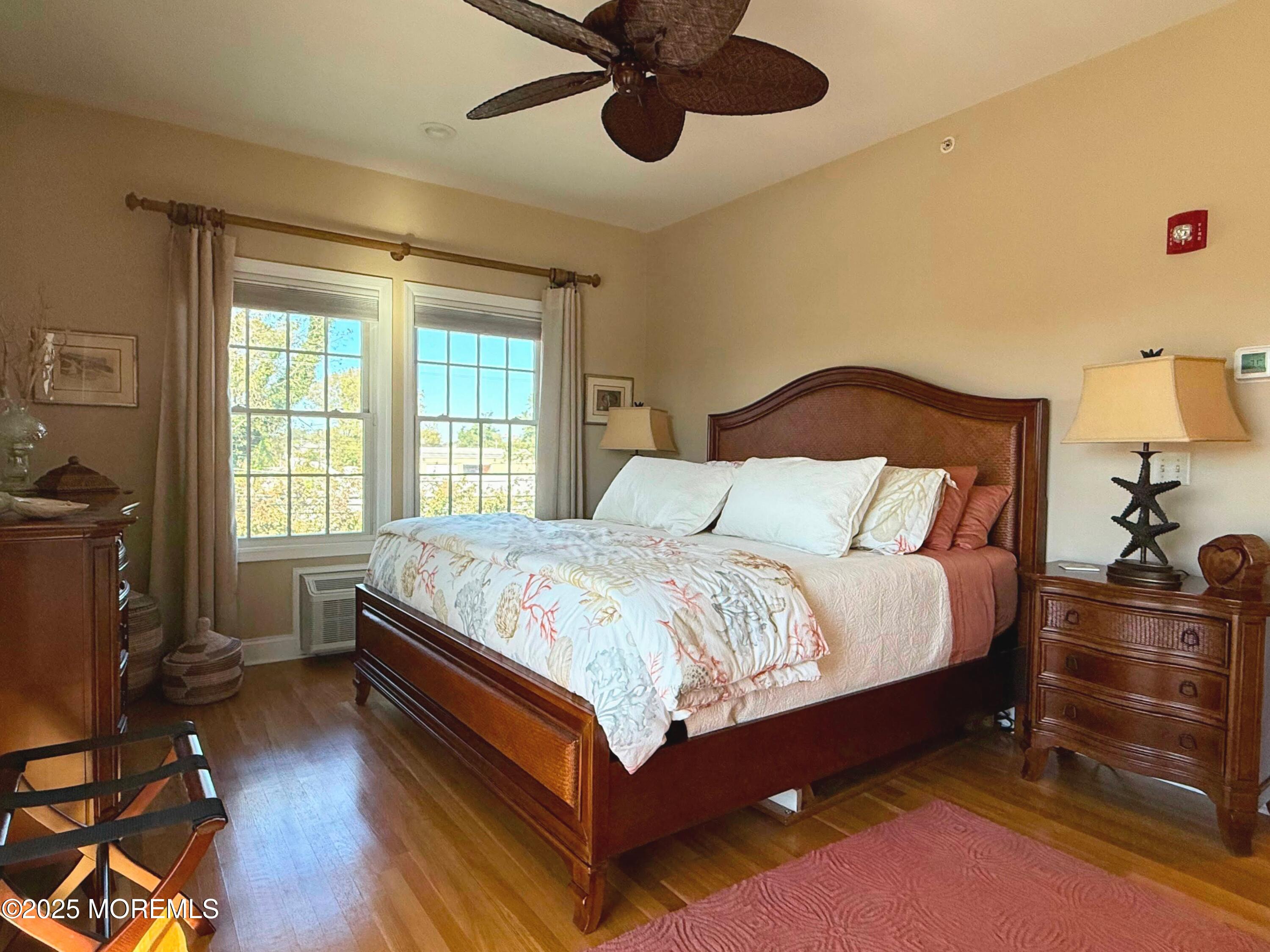 2 Main Street, Unit 308 Bradley Beach, NJ 07720 - Photo 15 of 31 a bedroom with a bed and wooden floor
