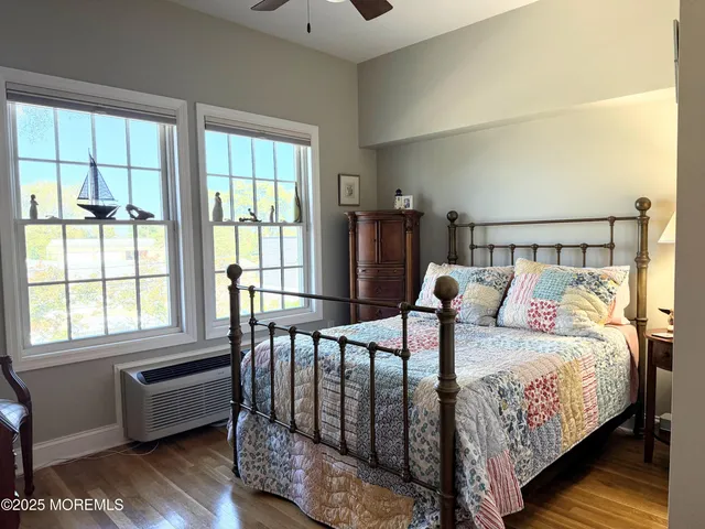a bedroom with bed couch and window