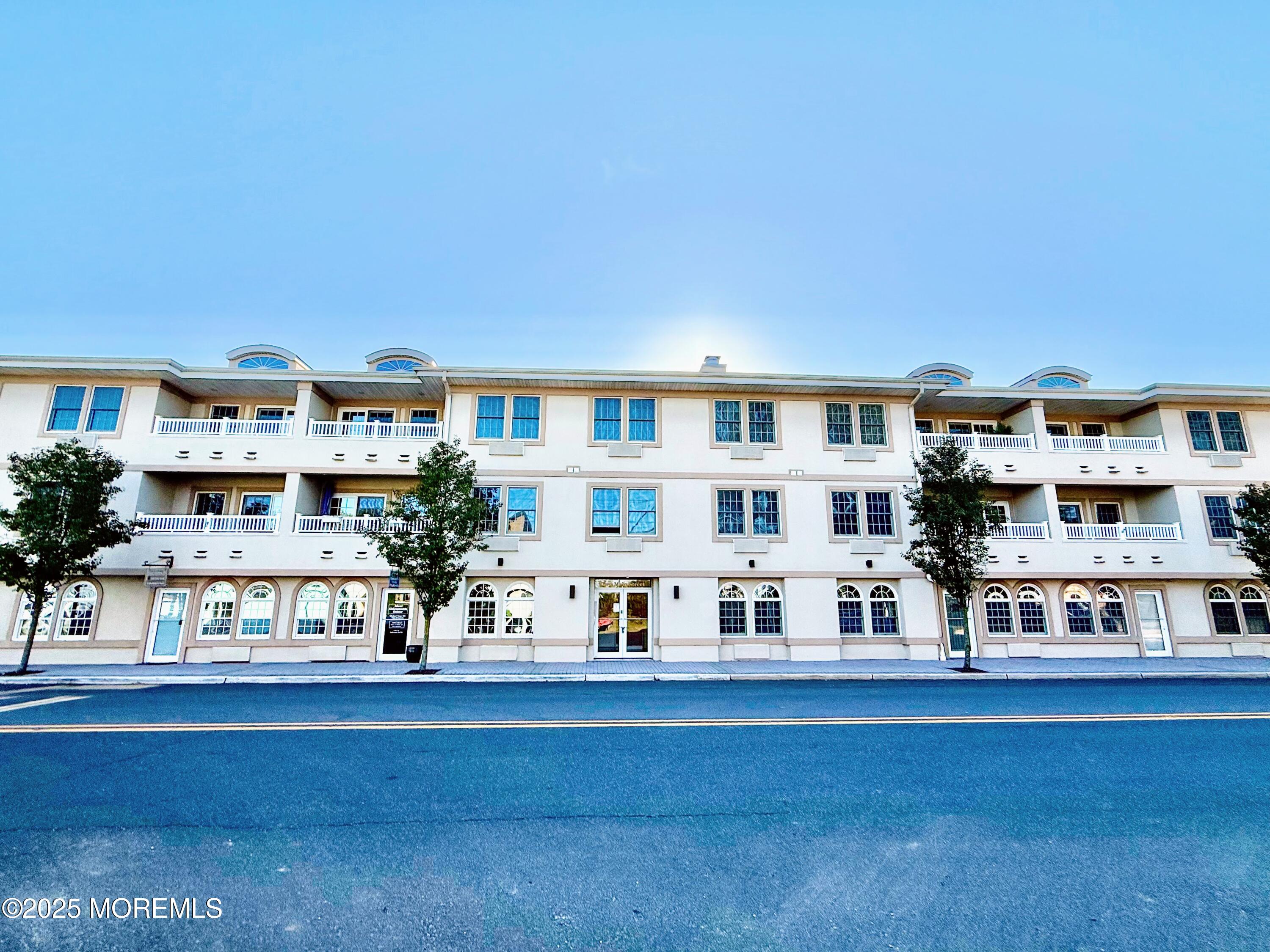 2 Main Street, Unit 308 Bradley Beach, NJ 07720 - Photo 2 of 31 a living room with furniture and a large window