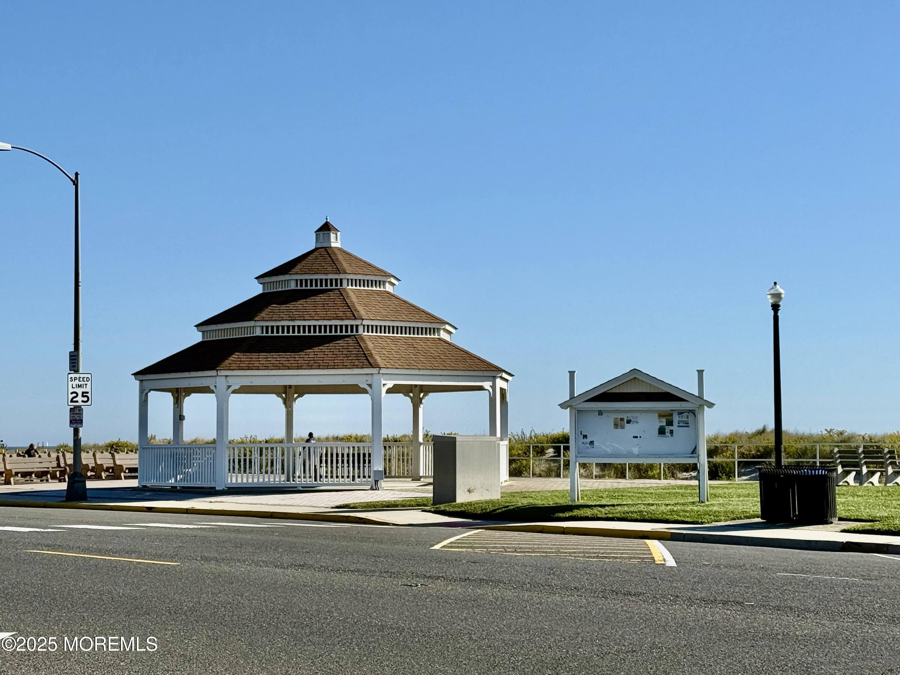 2 Main Street, Unit 308 Bradley Beach, NJ 07720 - Photo 29 of 31 a front view of a house with a garden and pathway