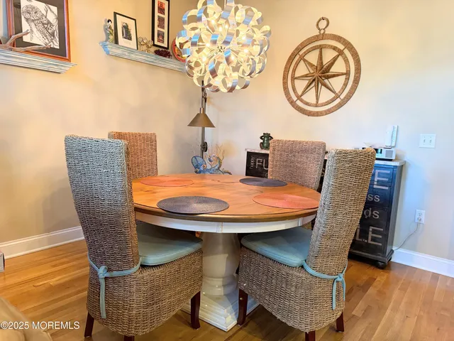 a dining room with furniture and wooden floor