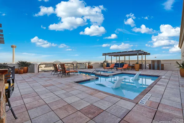 a view of a patio with swimming pool
