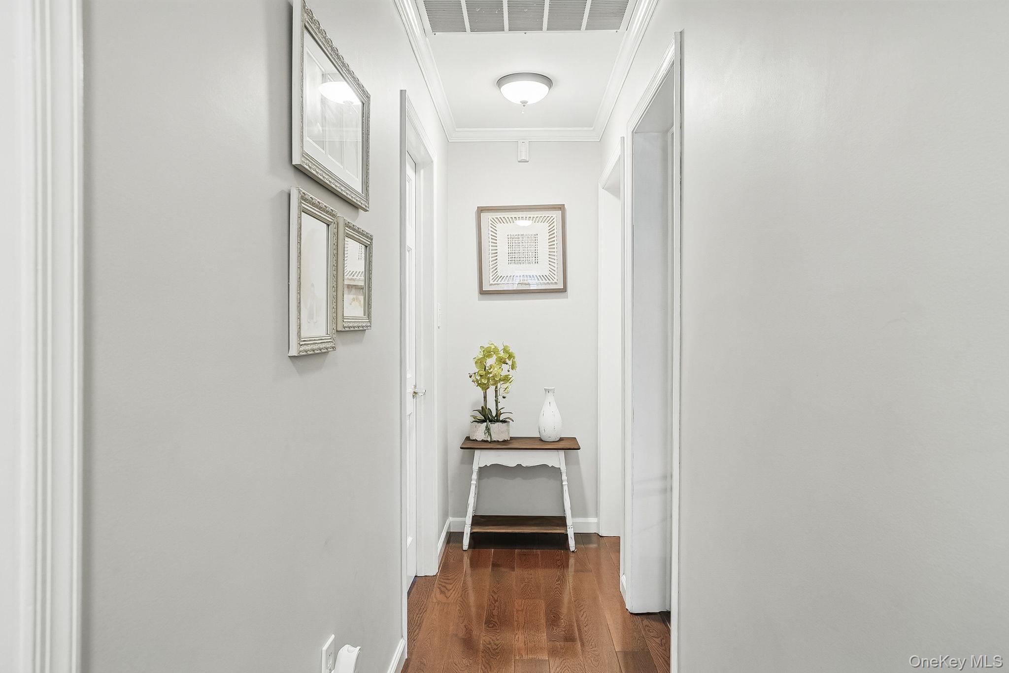 304 Church Road Putnam Valley, NY 10579 - Photo 30 of 50 Corridor with dark wood finished floors, ornamental molding, and baseboards