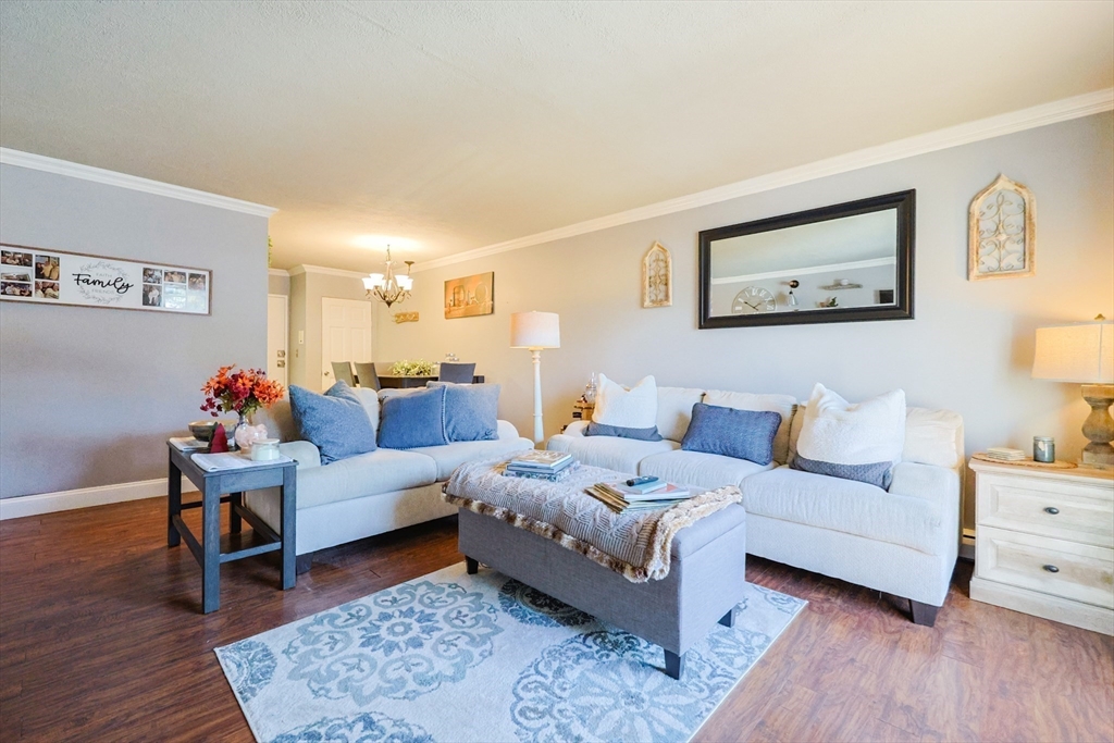 116 Boston Post Road East, Unit 101 Marlborough, MA 01752 - Photo 11 of 34 a living room with furniture and wooden floor