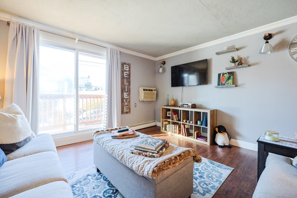 116 Boston Post Road East, Unit 101 Marlborough, MA 01752 - Photo 13 of 34 a living room with furniture and a window