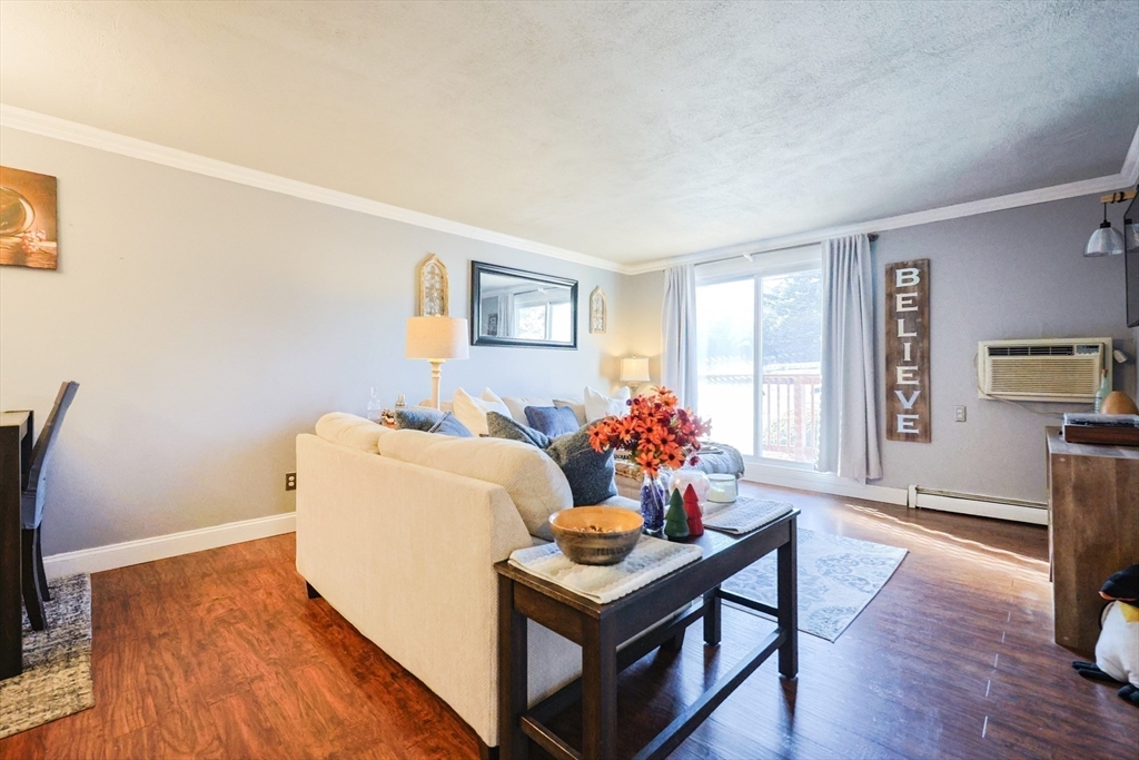 116 Boston Post Road East, Unit 101 Marlborough, MA 01752 - Photo 15 of 34 a living room with furniture and a table