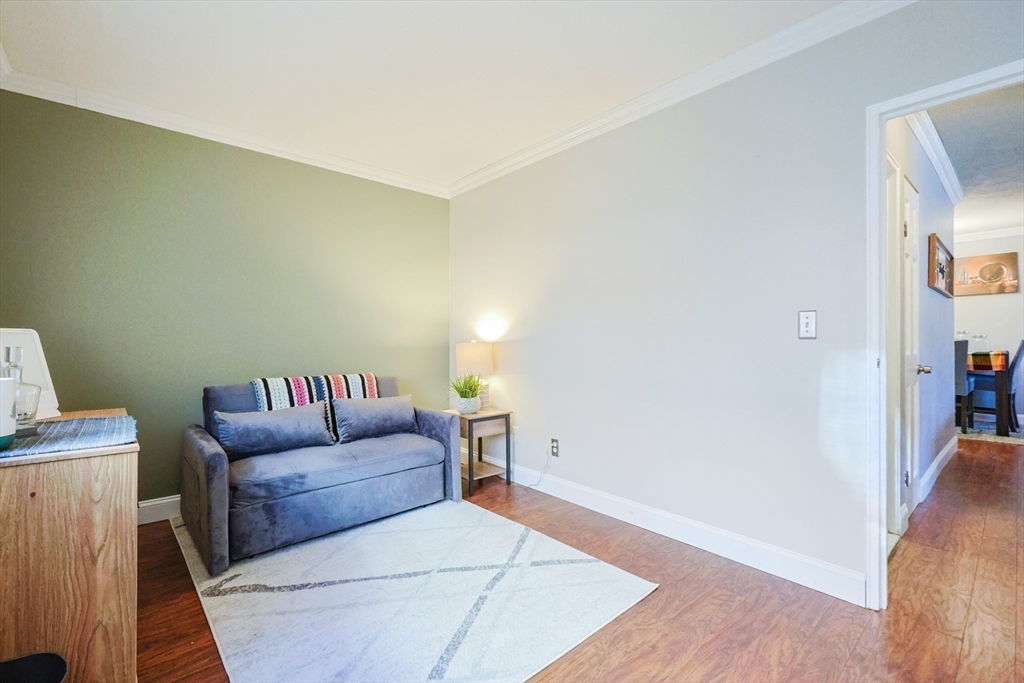 116 Boston Post Road East, Unit 101 Marlborough, MA 01752 - Photo 20 of 34 a living room with furniture and a wooden floor