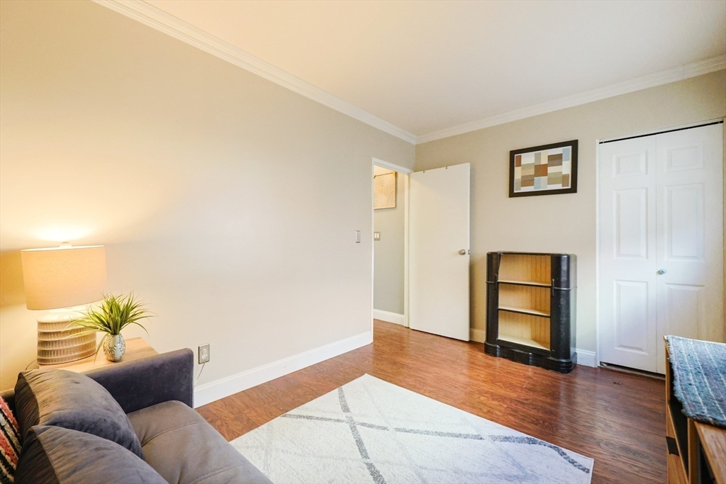 116 Boston Post Road East, Unit 101 Marlborough, MA 01752 - Photo 21 of 34 a living room with furniture and wooden floor
