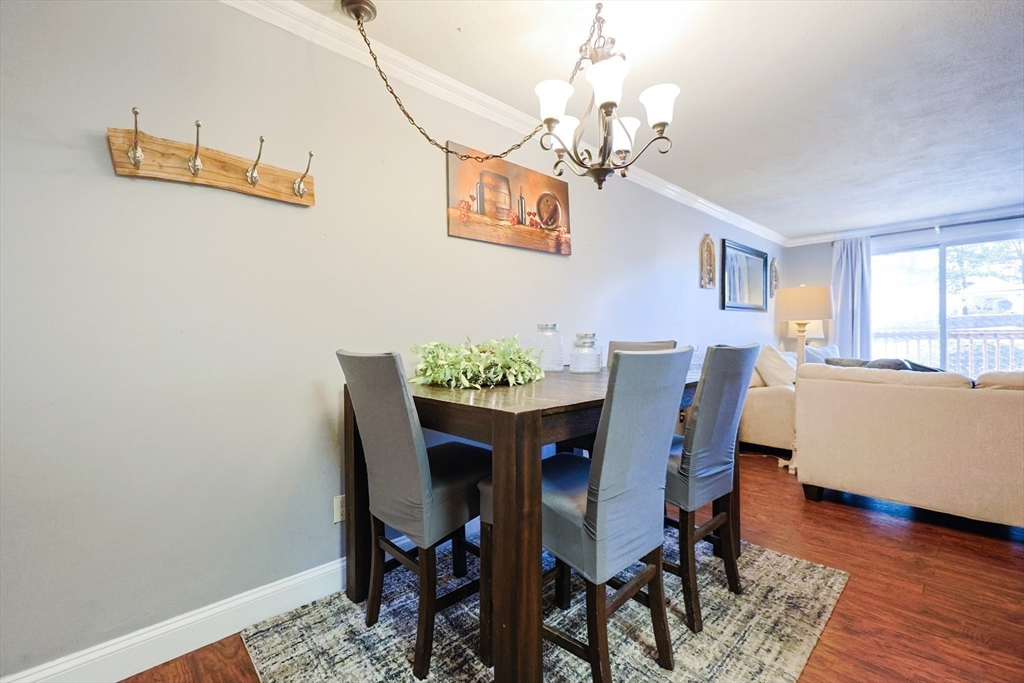 116 Boston Post Road East, Unit 101 Marlborough, MA 01752 - Photo 3 of 34 a view of a dining room with furniture wooden floor and chandelier