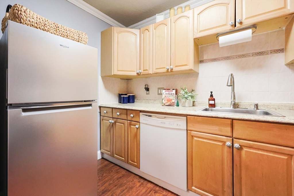 116 Boston Post Road East, Unit 101 Marlborough, MA 01752 - Photo 7 of 34 a kitchen with stainless steel appliances white cabinets and a refrigerator