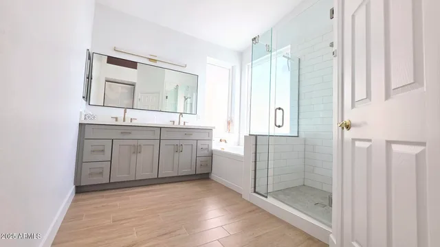 a bathroom with a shower sink and mirror