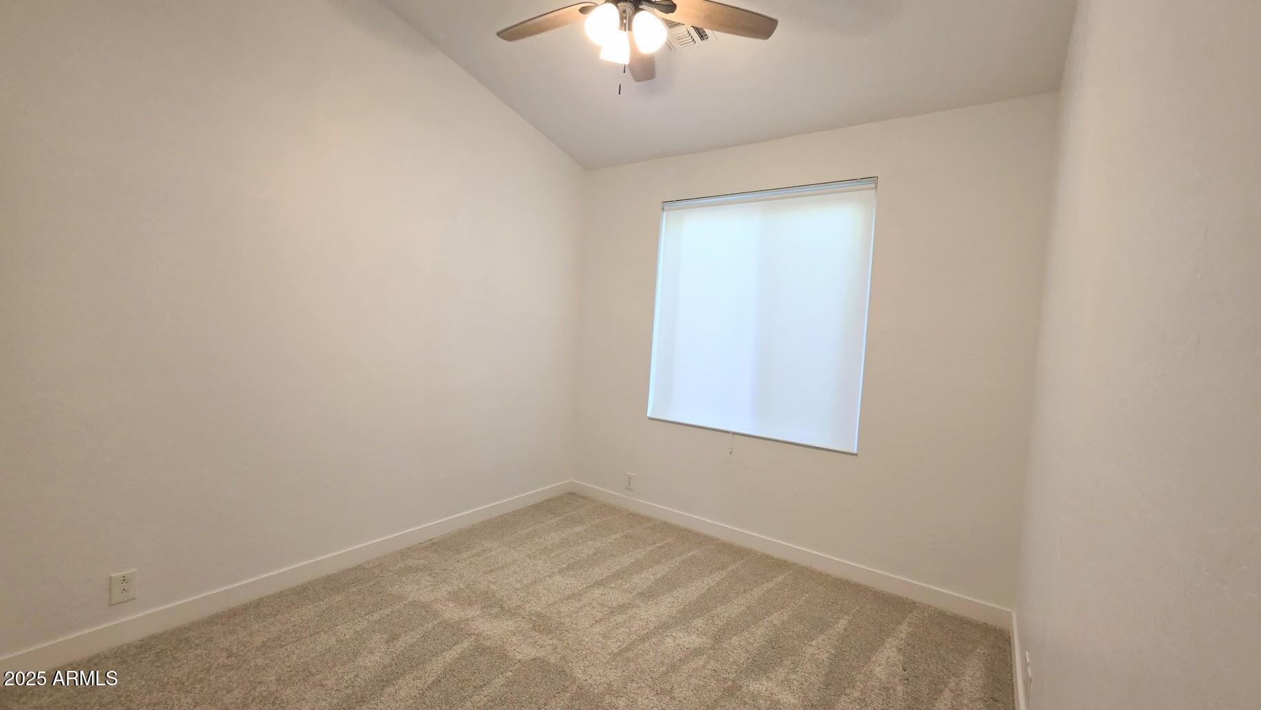 843 West Locust Dr. Chandler, AZ 85248 - Photo 18 of 23 an empty room with a chandelier fan and windows