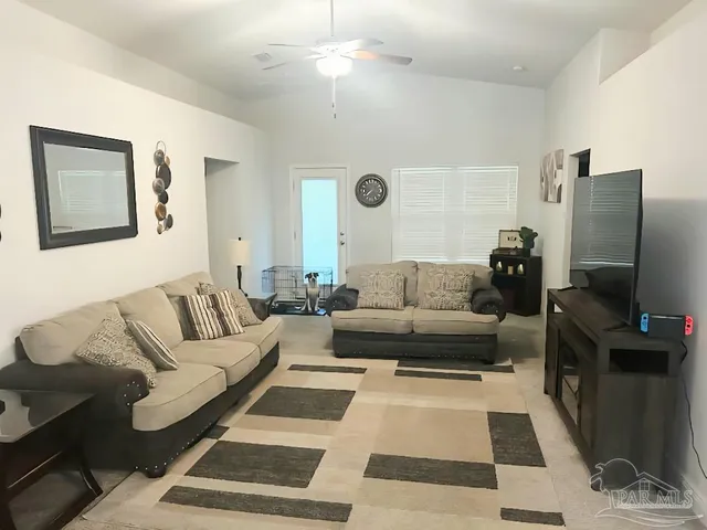 a living room with furniture and a flat screen tv