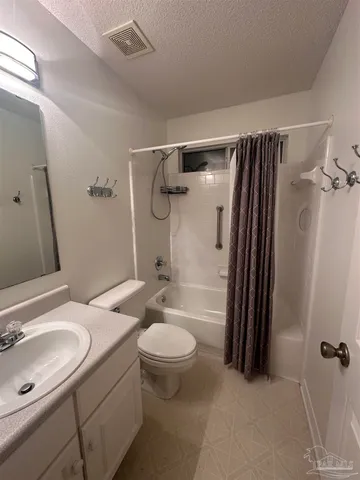 a bathroom with a sink toilet a mirror and shower