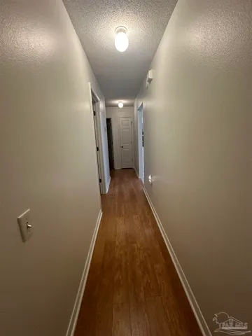 a kitchen with white cabinets and appliances