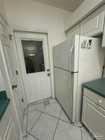 a kitchen with granite countertop cabinets and white appliances