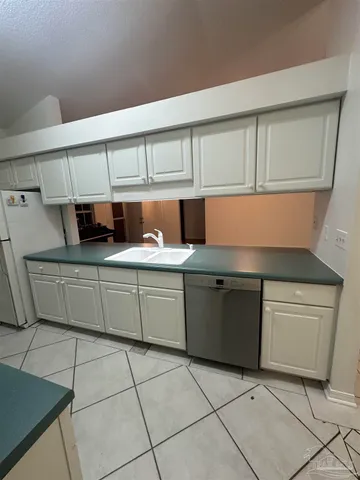 a kitchen with a sink a stove and cabinets