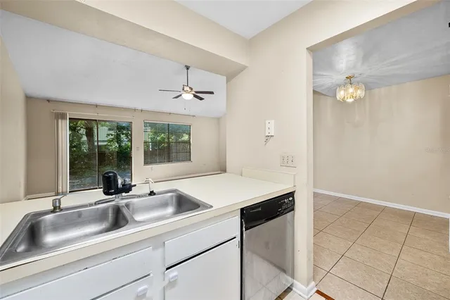 a kitchen with a sink and large window