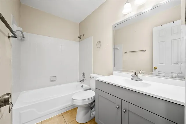 an empty room with a window and a ceiling fan