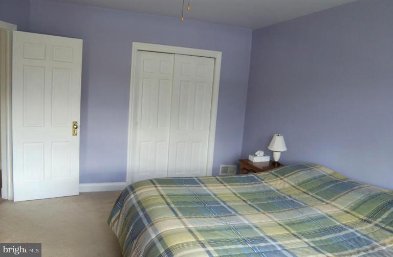 403 Greenlow Road Catonsville, MD 21228 - Photo 12 of 26 a bedroom with a bed and lamp