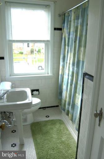 403 Greenlow Road Catonsville, MD 21228 - Photo 20 of 26 a bathroom with a sink toilet and window