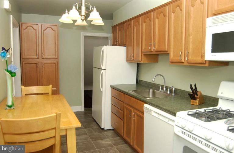 403 Greenlow Road Catonsville, MD 21228 - Photo 3 of 26 a kitchen with granite countertop a sink stainless steel appliances a refrigerator and a stove top oven