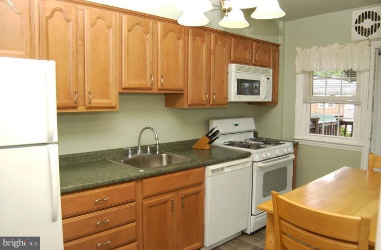 403 Greenlow Road Catonsville, MD 21228 - Photo 9 of 26 a kitchen with stainless steel appliances granite countertop a sink stove and cabinets