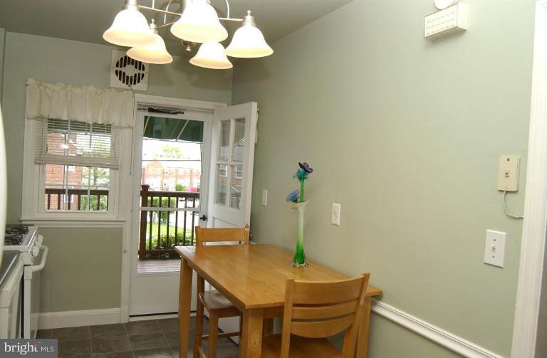 403 Greenlow Road Catonsville, MD 21228 - Photo 10 of 26 a dining room with wooden table and chandelier