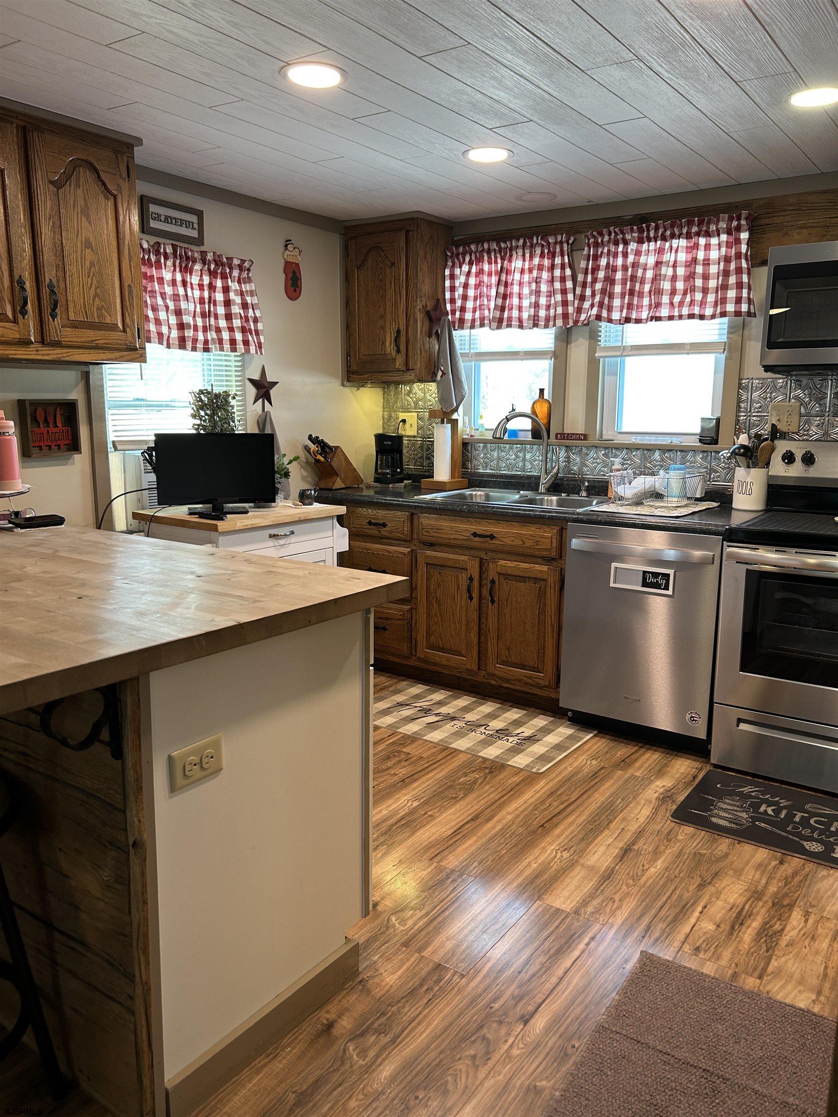 390 Jones Island Road Cedarville, NJ 08311 - Photo 11 of 41 a kitchen with a sink a stove and cabinets