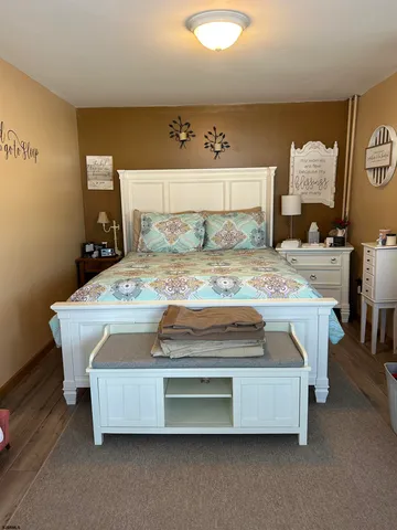 a bedroom with a bed and a night stand