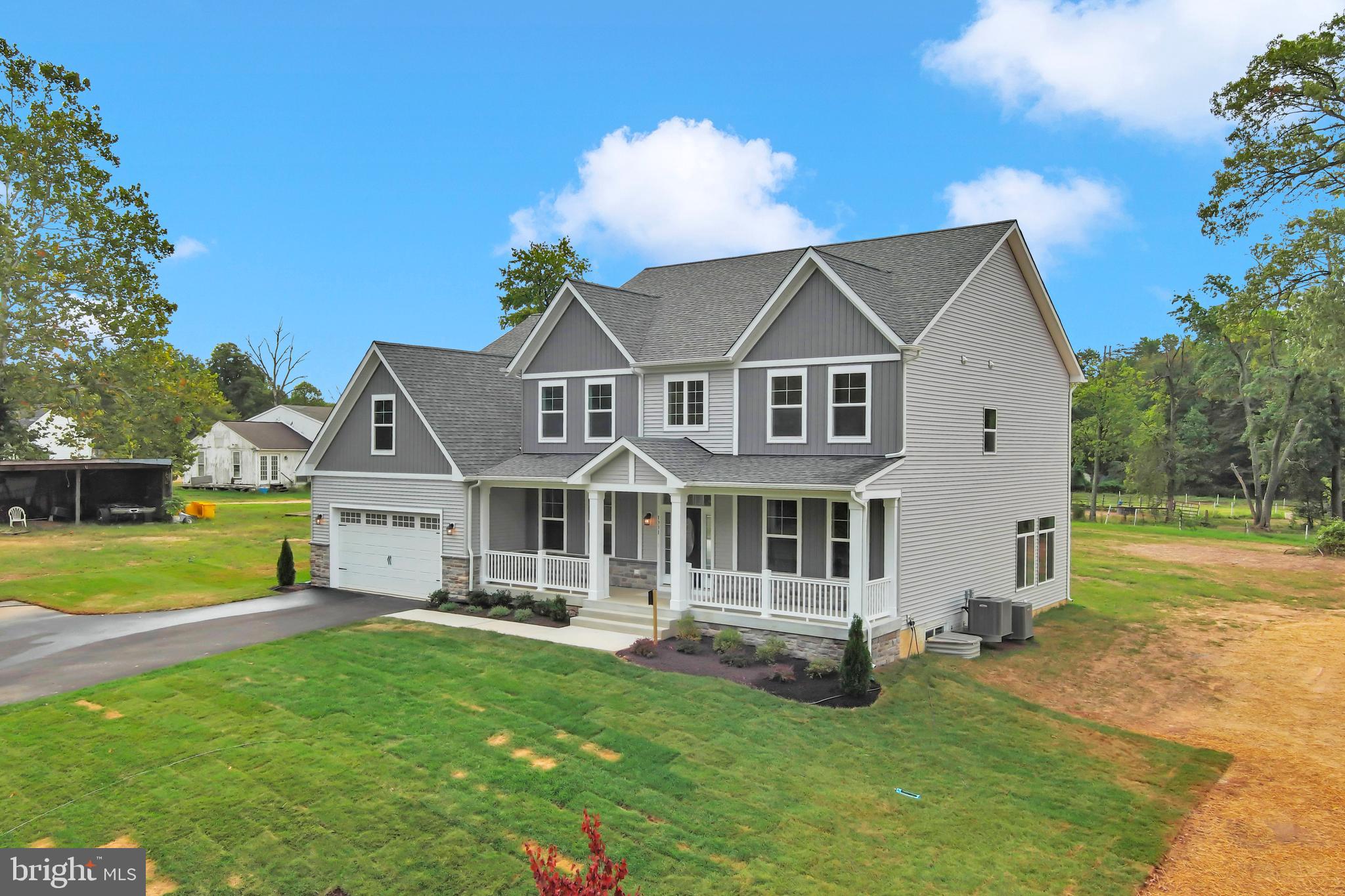 1331 German Driveway Hanover, MD 21076 - Photo 2 of 87 a front view of a house with a yard table and chairs