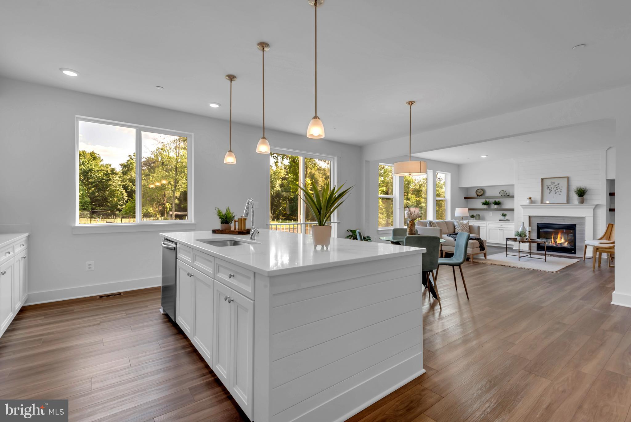 1331 German Driveway Hanover, MD 21076 - Photo 22 of 87 a large white kitchen with a large island oven a stove and a wooden floors