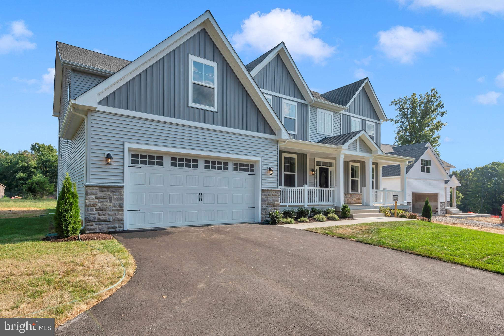 1331 German Driveway Hanover, MD 21076 - Photo 3 of 87 a front view of a house with a yard and garage