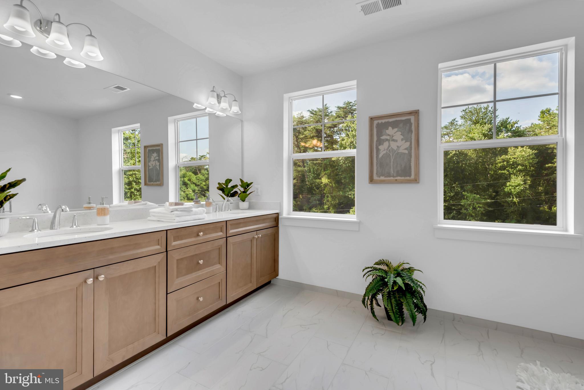 1331 German Driveway Hanover, MD 21076 - Photo 35 of 87 a spacious en suite bathroom with a granite countertop sink a large mirror and a window