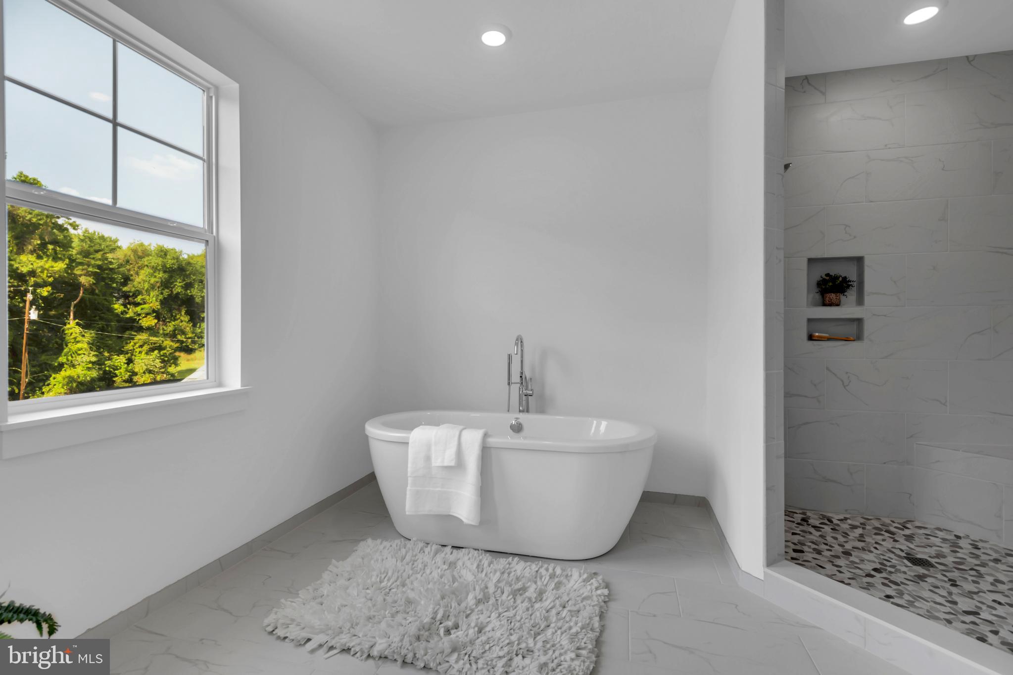 1331 German Driveway Hanover, MD 21076 - Photo 38 of 87 a white bath tub sitting in a bathroom next to a window