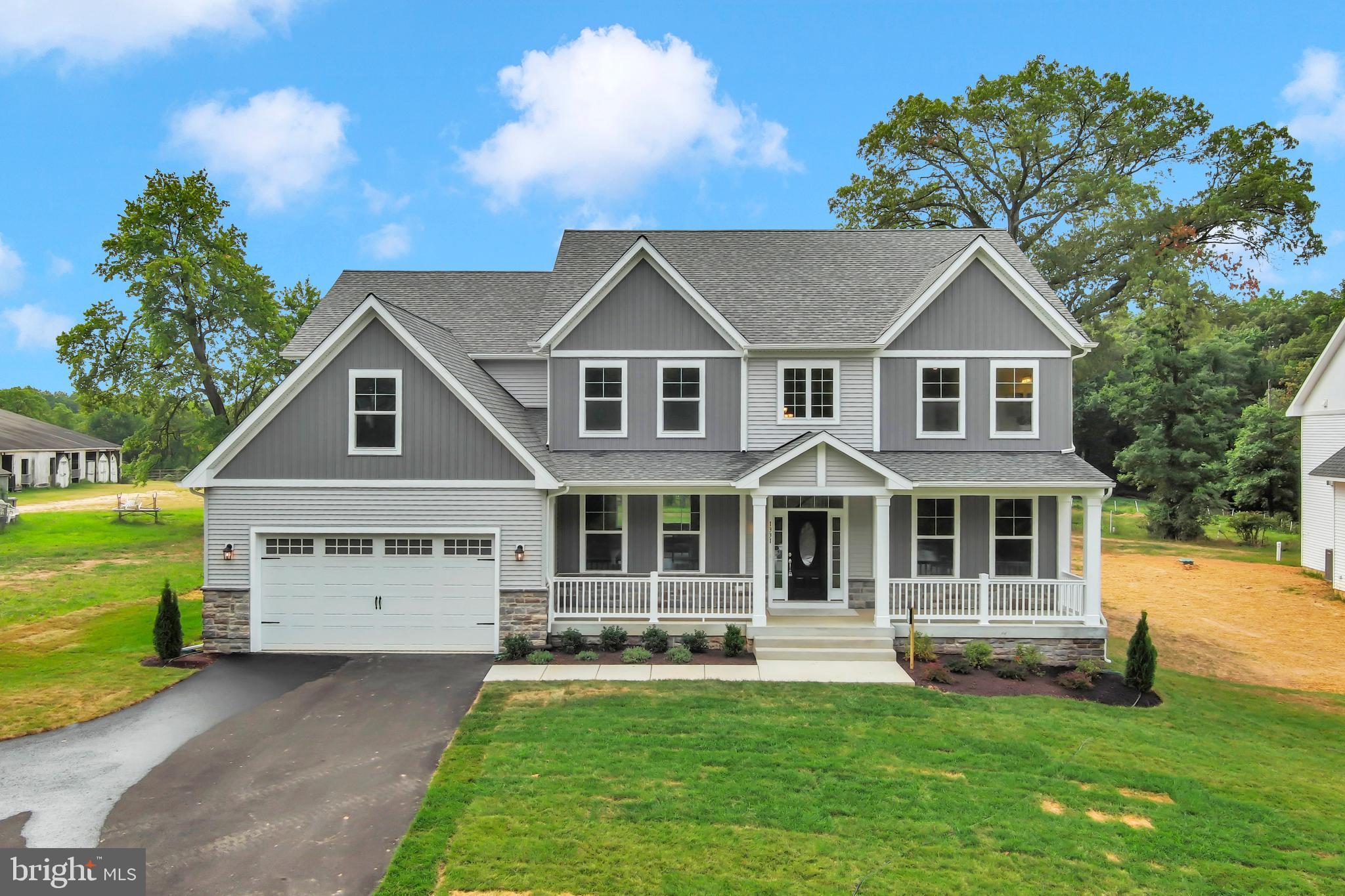 1331 German Driveway Hanover, MD 21076 - Photo 4 of 87 a front view of a house with a garden and yard
